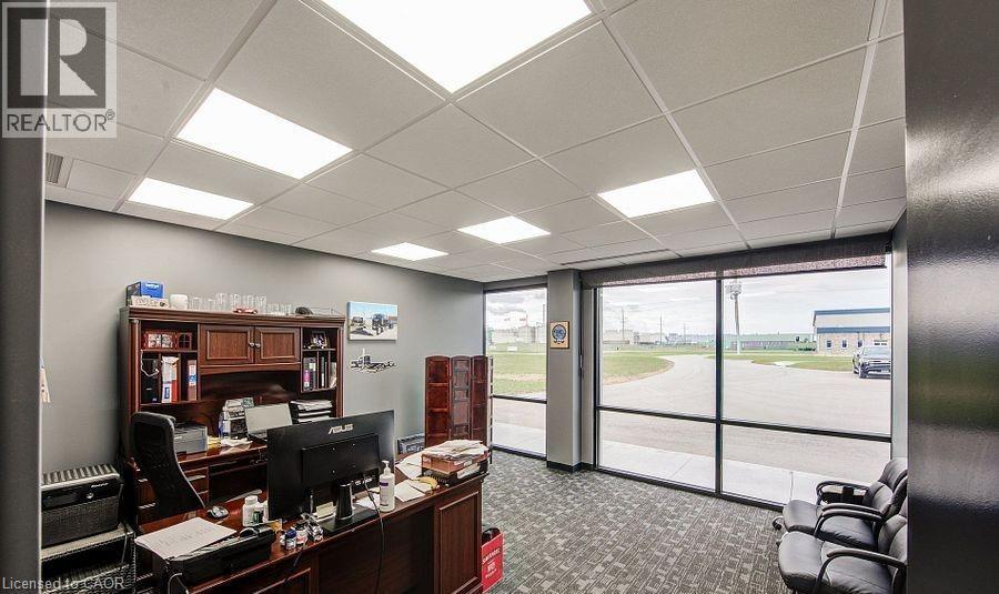 Office with a paneled ceiling and floor to ceiling windows - 55 Progress Drive E, Aylmer, ON