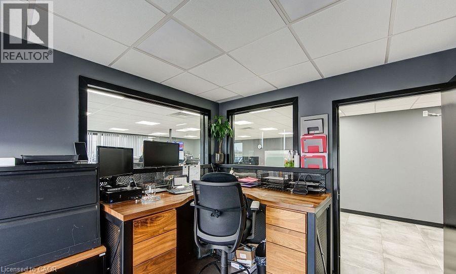 Office area featuring a drop ceiling and light tile patterned flooring - 55 Progress Drive E, Aylmer, ON
