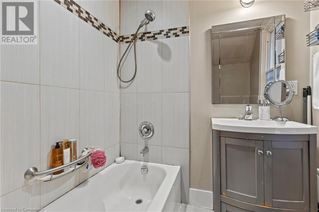 Bathroom with vanity and washtub / shower combination - 181 West Avenue N, Hamilton, ON - Indoor Photo Showing Bathroom