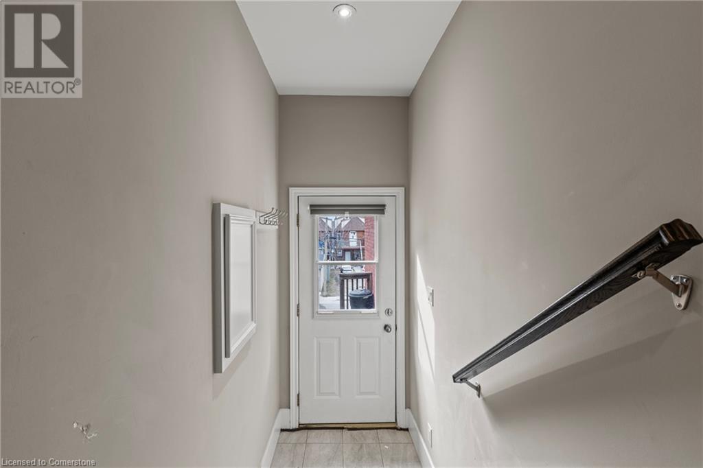 Entryway featuring light tile patterned floors and baseboards - 181 West Avenue N, Hamilton, ON - Indoor Photo Showing Other Room