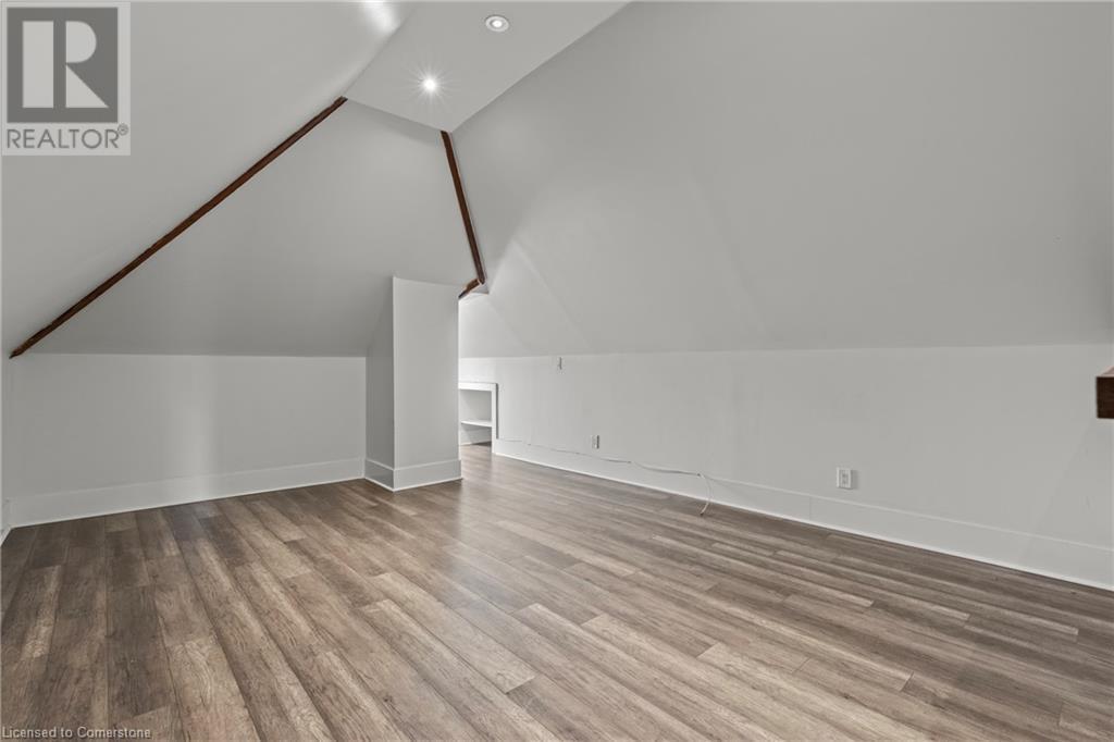 Bonus room featuring recessed lighting, baseboards, lofted ceiling, and wood finished floors - 181 West Avenue N, Hamilton, ON - Indoor Photo Showing Other Room