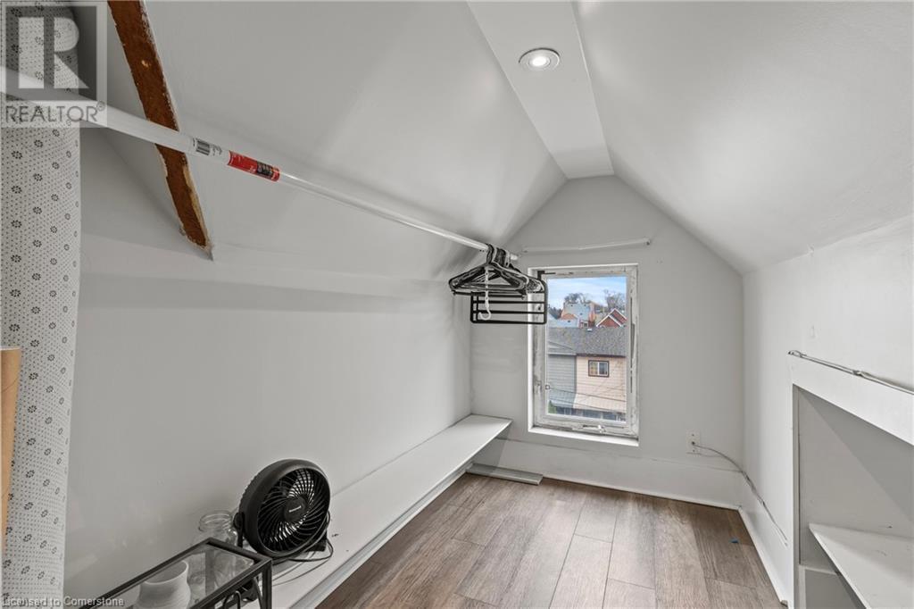 Spacious closet with lofted ceiling and wood finished floors - 181 West Avenue N, Hamilton, ON - Indoor Photo Showing Other Room