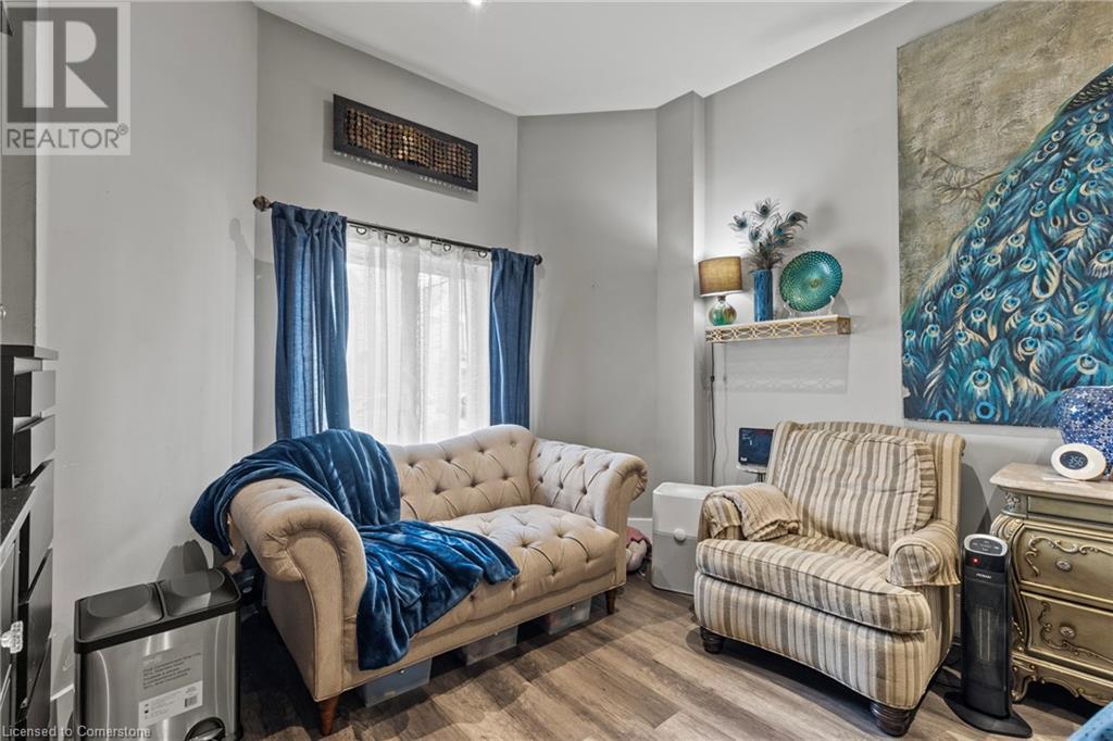 Living area featuring wood finished floors - 181 West Avenue N, Hamilton, ON - Indoor