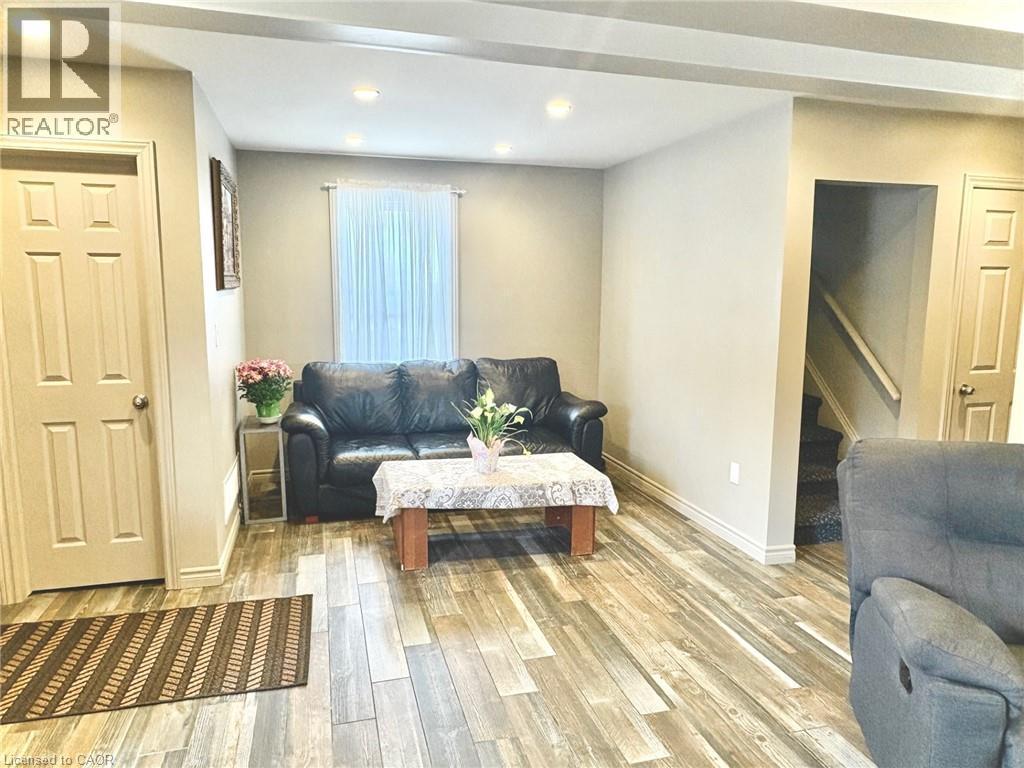 Living space featuring wood-finish flooring, recessed lighting, and a neutral wall palette - 199 Kimberly Drive, Hamilton, ON - Indoor Photo Showing Other Room