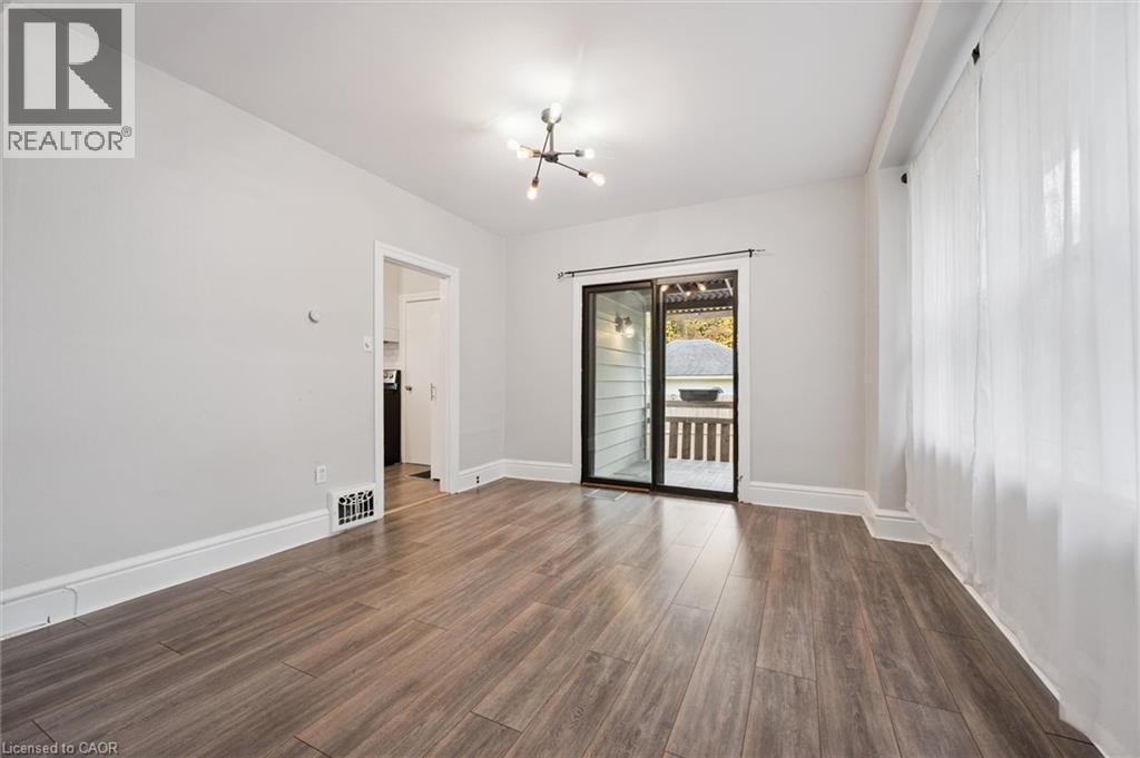 Unfurnished room with a chandelier and dark wood finished floors - 41 Rose Street, Kitchener, ON - Indoor Photo Showing Other Room