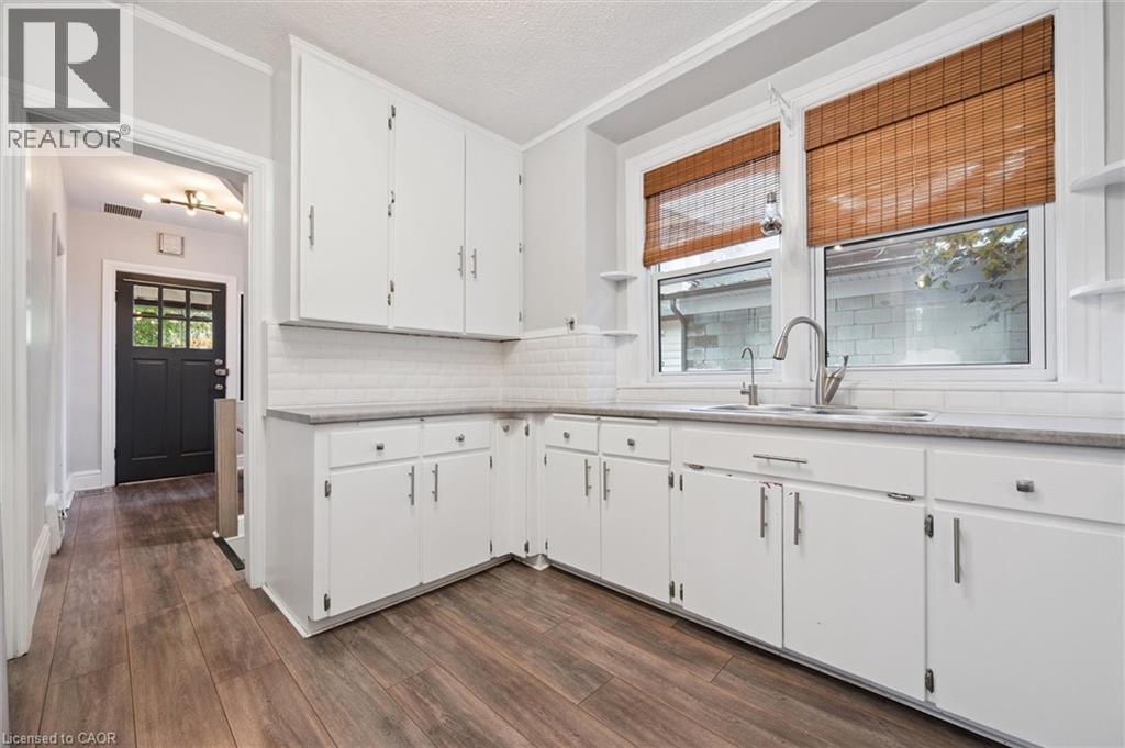 Kitchen featuring open shelves, white cabinetry, tasteful backsplash, dark wood-type flooring, and a textured ceiling - 41 Rose Street, Kitchener, ON - Indoor Photo Showing Kitchen