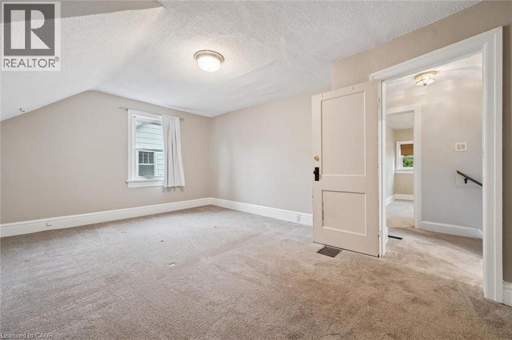 Additional living space with healthy amount of natural light, a textured ceiling, carpet floors, and lofted ceiling - 41 Rose Street, Kitchener, ON - Indoor Photo Showing Other Room