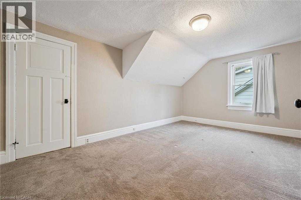 Bonus room featuring a textured ceiling, carpet floors, and lofted ceiling - 41 Rose Street, Kitchener, ON - Indoor Photo Showing Other Room