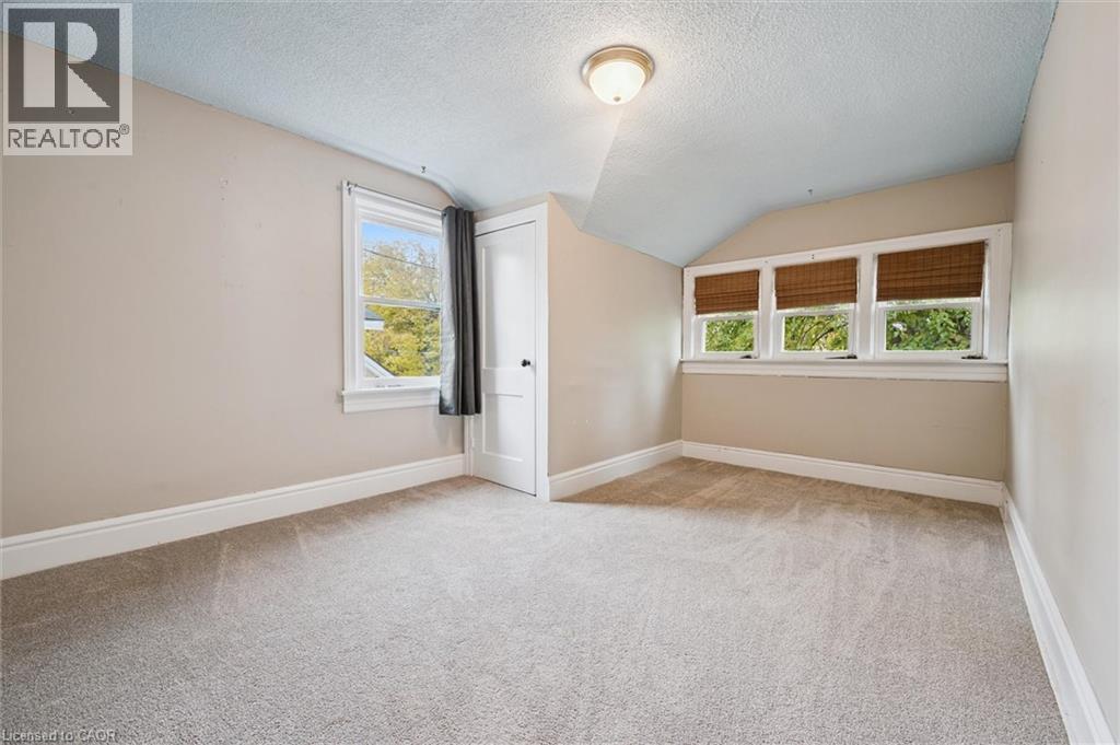 Additional living space featuring a textured ceiling, lofted ceiling, and light carpet - 41 Rose Street, Kitchener, ON - Indoor Photo Showing Other Room