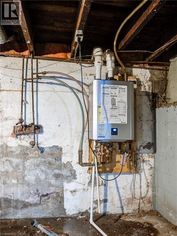 Unfinished Basement Showing Modern On Demand Hot Water Tank - 1 Rathgar Street, London, ON - Indoor Photo Showing Basement