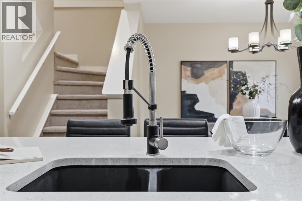 117 Panatella Park Nw, Calgary, AB - Indoor Photo Showing Kitchen With Double Sink