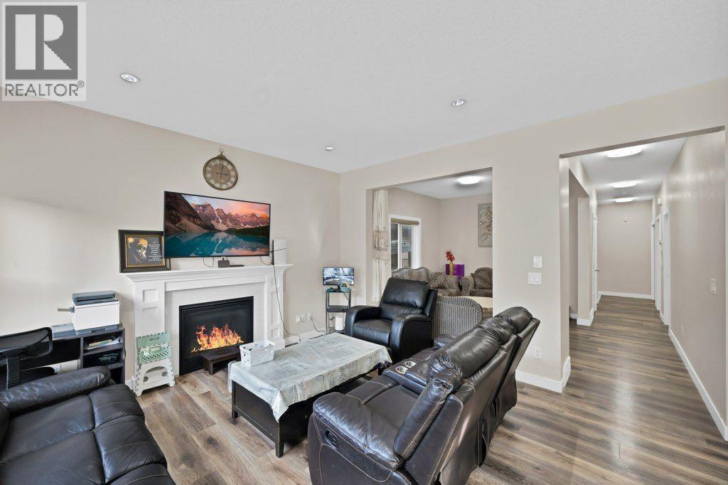 93 Saddlestone Place Ne, Calgary, AB - Indoor Photo Showing Living Room With Fireplace