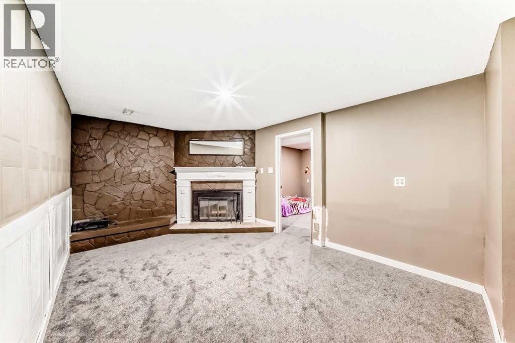 707 Malvern Drive Ne, Calgary, AB - Indoor With Fireplace