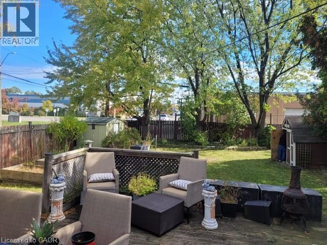 Fenced backyard featuring a storage unit, an outdoor living space, and a deck - 89 Deschene Avenue, Hamilton, ON - Outdoor