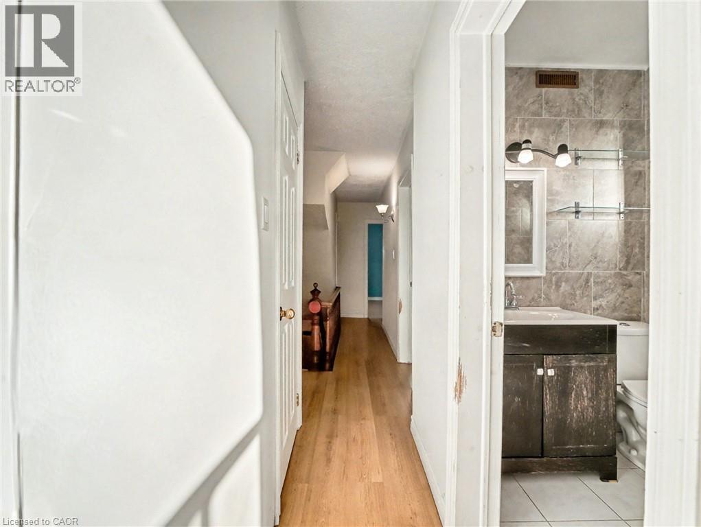 Corridor with baseboards and light wood-style flooring - 23 Oak Avenue, Hamilton, ON - Indoor Photo Showing Other Room