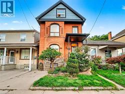 Victorian house with brick siding and a porch -