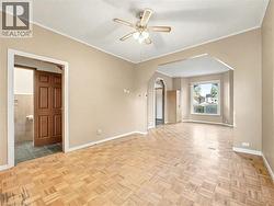 Spare room with ornamental molding, arched walkways, and ceiling fan -