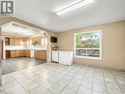 Washroom featuring light tile patterned flooring and arched walkways -