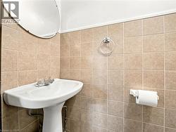 Bathroom featuring tile walls -