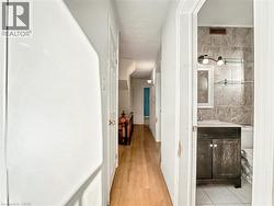 Corridor with baseboards and light wood-style flooring -