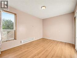 Spare room with light wood-style floors and a baseboard radiator -