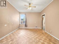 Empty room featuring crown molding, a textured ceiling, and a ceiling fan -