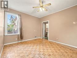 Empty room with crown molding and ceiling fan -