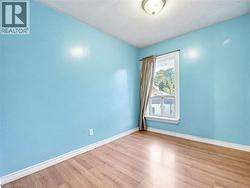 Empty room with wood finished floors and a textured ceiling -