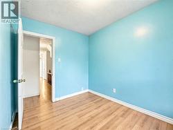 Spare room featuring wood finished floors and a textured ceiling -