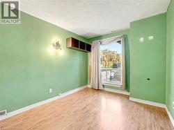 Spare room with light wood-type flooring and a textured ceiling -