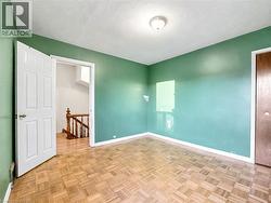 Spare room featuring a textured ceiling and baseboards -