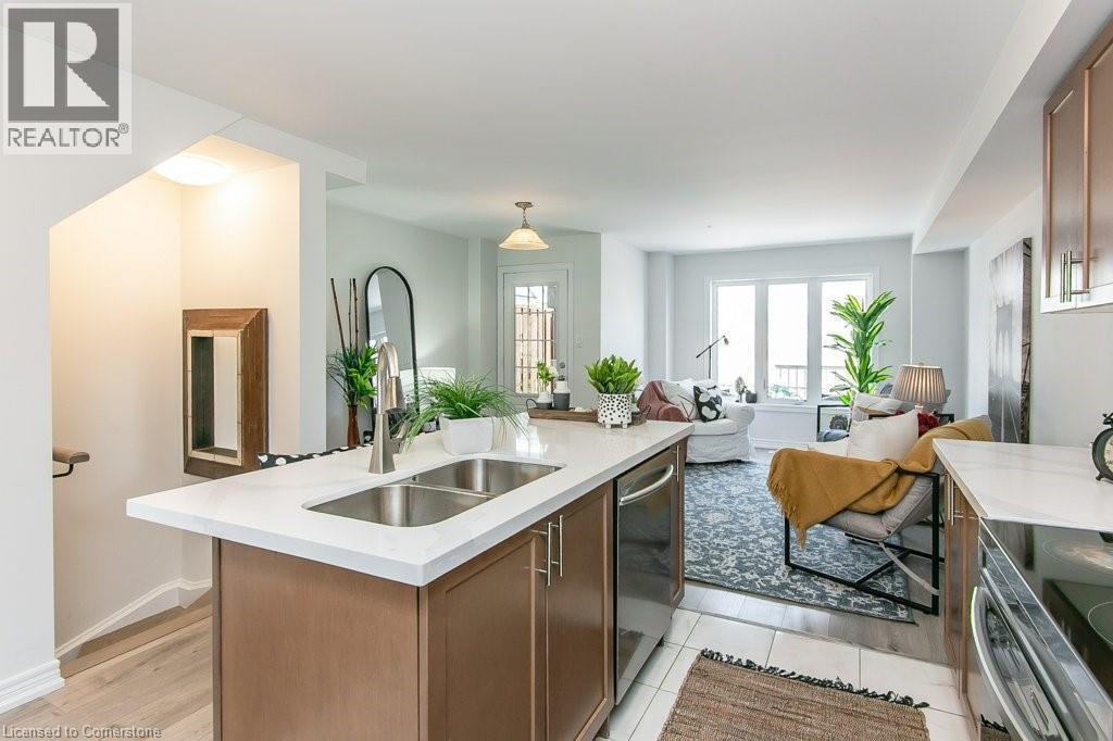 Kitchen with light countertops, appliances with stainless steel finishes, open floor plan, an island with sink, and light tile patterned floors - 386 Linden Drive, Cambridge, ON - Indoor Photo Showing Kitchen With Double Sink With Upgraded Kitchen