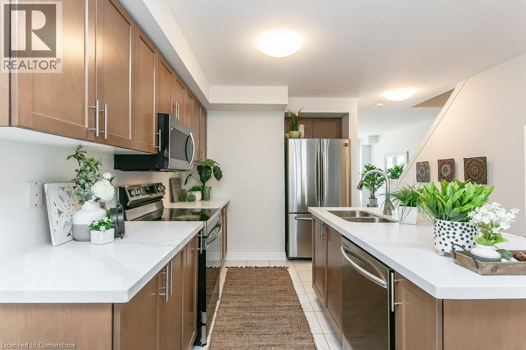 Kitchen with appliances with stainless steel finishes, light countertops, brown cabinetry, and light tile patterned flooring - 386 Linden Drive, Cambridge, ON - Indoor Photo Showing Kitchen With Double Sink With Upgraded Kitchen