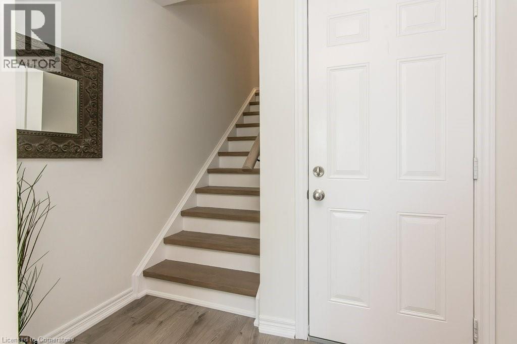 First floor door to garage and Staircase with baseboards and wood finished floors - 386 Linden Drive, Cambridge, ON - Indoor Photo Showing Other Room