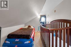 Carpeted bedroom with lofted ceiling -