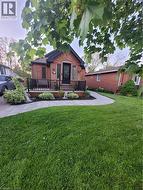 Back of house with a lawn -