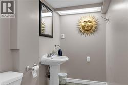 Bathroom featuring toilet and baseboards -