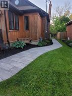 View of home's exterior with board and batten siding and a chimney -
