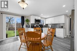 Dining area with light wood-style floors and recessed lighting -