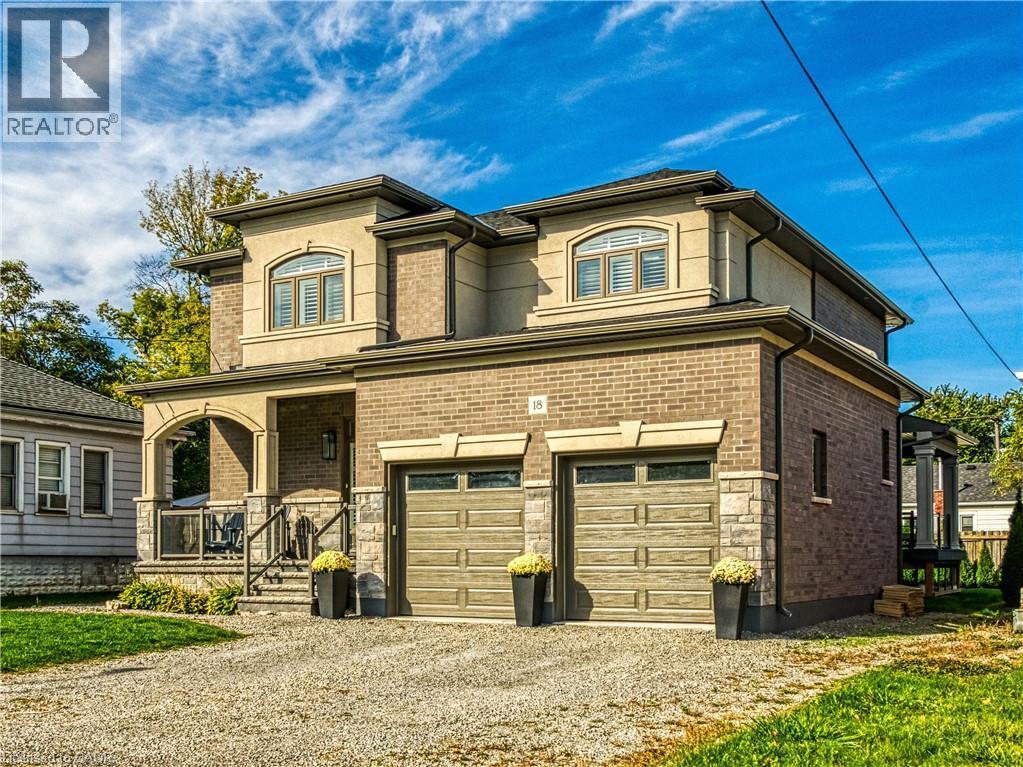 View of front of property featuring covered porch, gravel driveway, an attached garage, and brick siding - 18 David Avenue, Hamilton, ON - Outdoor