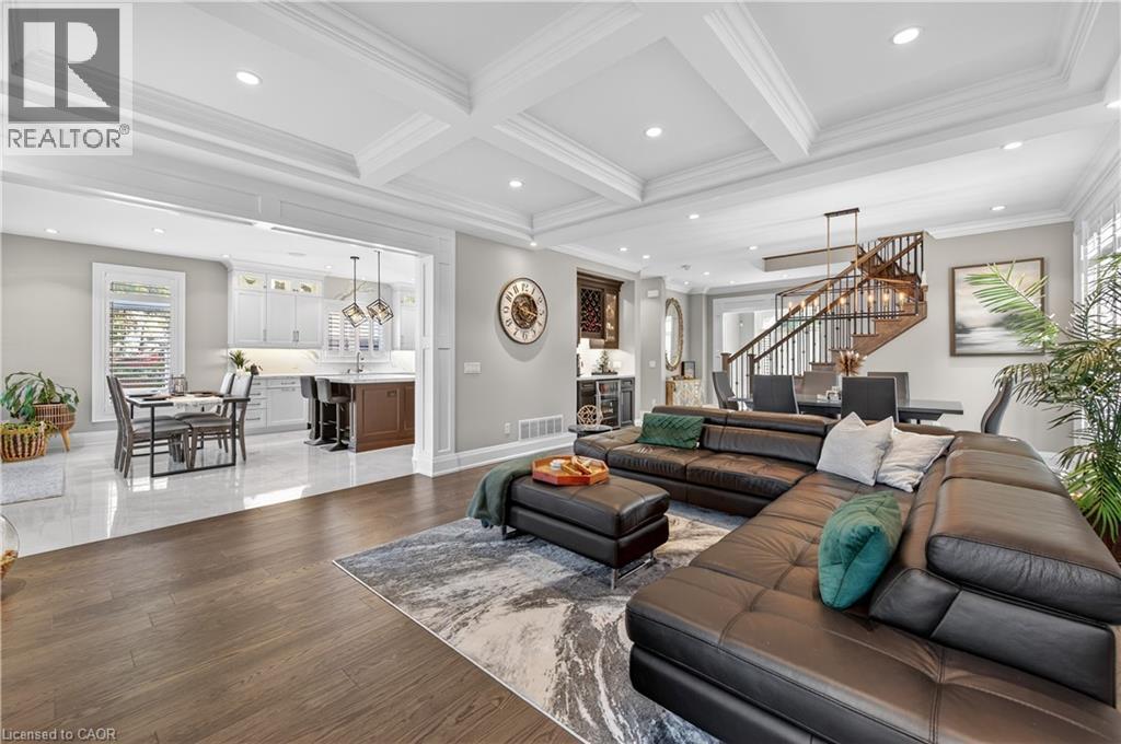 Living room featuring stairway, crown molding, beam ceiling, recessed lighting, and dark wood-style flooring - 18 David Avenue, Hamilton, ON - Indoor Photo Showing Living Room