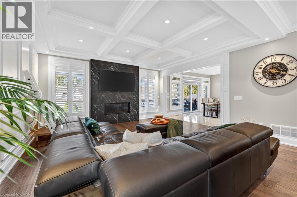 Living room with wood finished floors, a fireplace, coffered ceiling, beam ceiling, and recessed lighting - 18 David Avenue, Hamilton, ON - Indoor Photo Showing Living Room With Fireplace