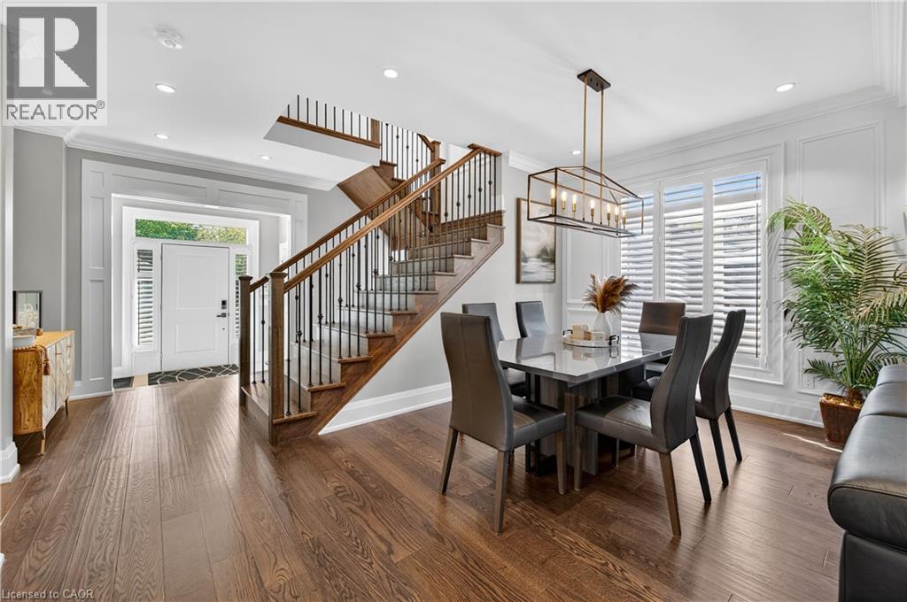 Dining space featuring ornamental molding, dark wood finished floors, a chandelier, recessed lighting, and stairway - 18 David Avenue, Hamilton, ON - Indoor Photo Showing Dining Room