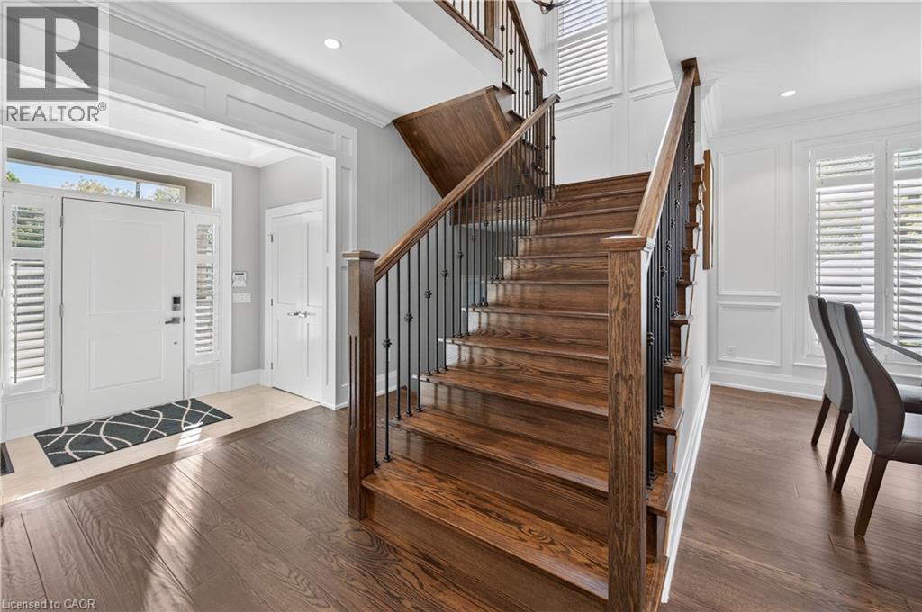 Foyer entrance featuring ornamental molding, dark wood-style flooring, stairs, and recessed lighting - 18 David Avenue, Hamilton, ON - Indoor Photo Showing Other Room