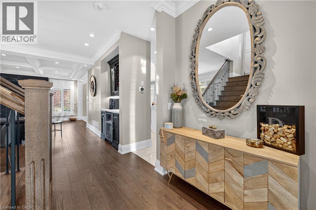 Hall with crown molding, recessed lighting, coffered ceiling, beamed ceiling, and dark wood-style flooring - 18 David Avenue, Hamilton, ON - Indoor