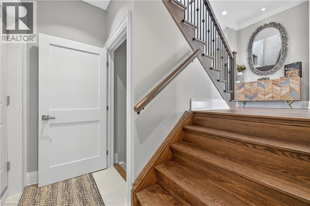 Staircase with tile patterned flooring, ornamental molding, and recessed lighting - 18 David Avenue, Hamilton, ON - Indoor Photo Showing Other Room