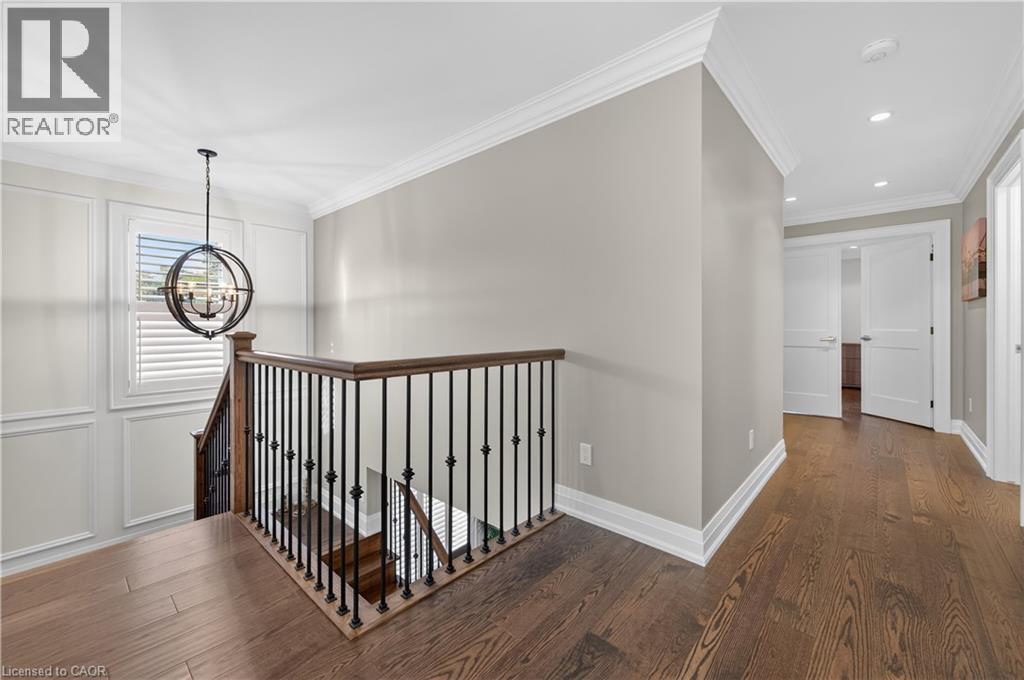 Hall with an upstairs landing, ornamental molding, dark wood finished floors, a chandelier, and recessed lighting - 18 David Avenue, Hamilton, ON - Indoor Photo Showing Other Room