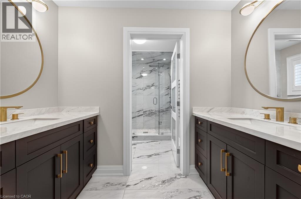 Full bathroom featuring light marble finish floors, a marble finish shower, and two vanities - 18 David Avenue, Hamilton, ON - Indoor Photo Showing Bathroom