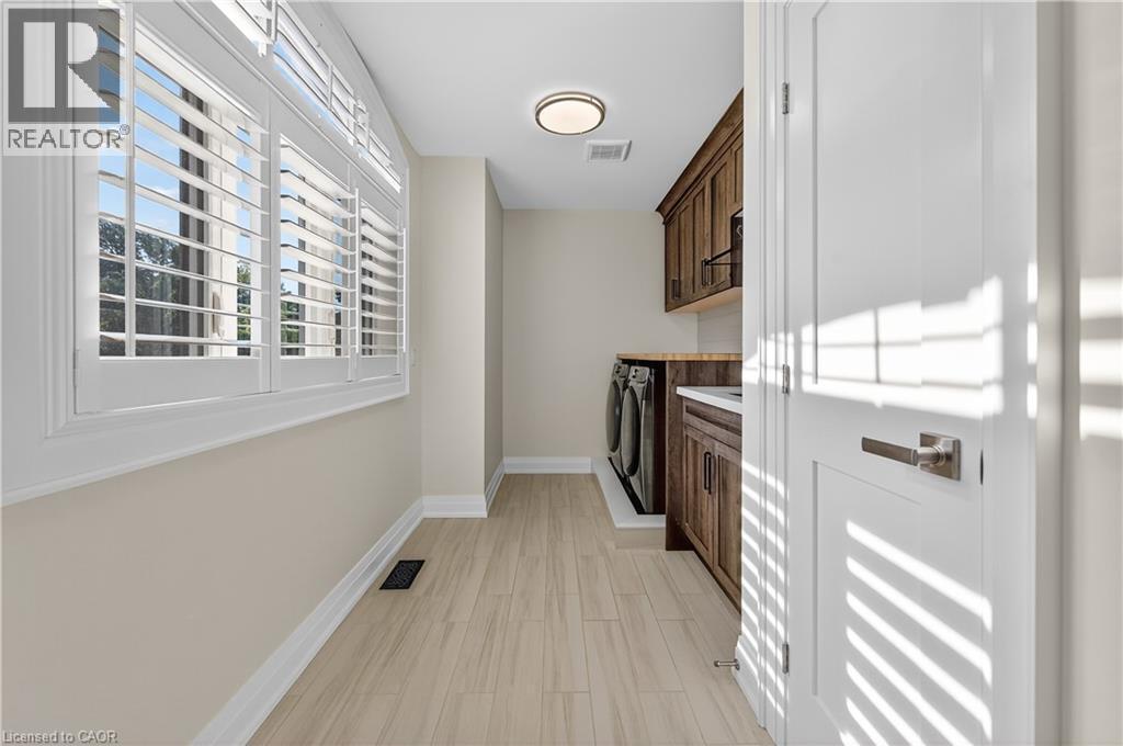 Laundry room featuring cabinet space and washer and clothes dryer - 18 David Avenue, Hamilton, ON - Indoor Photo Showing Other Room