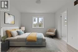 Bedroom with wood finished floors and baseboards -